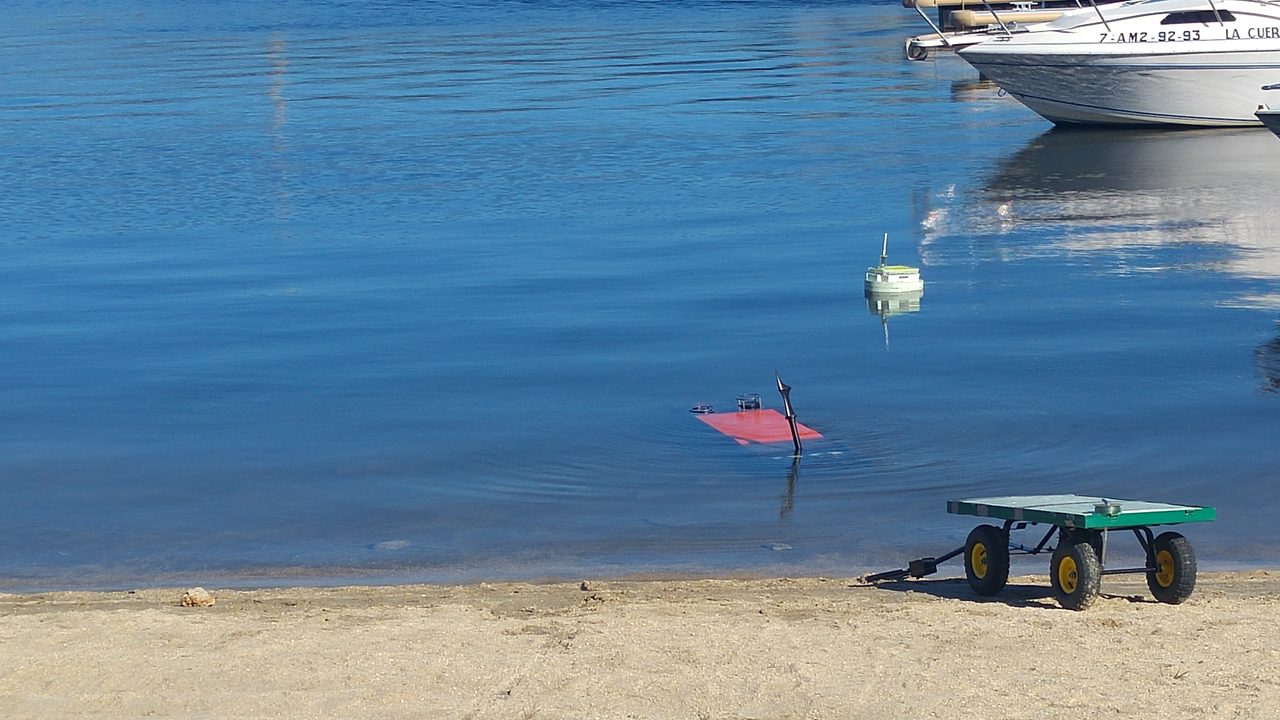 Submarine robot partially submerged during a field test.