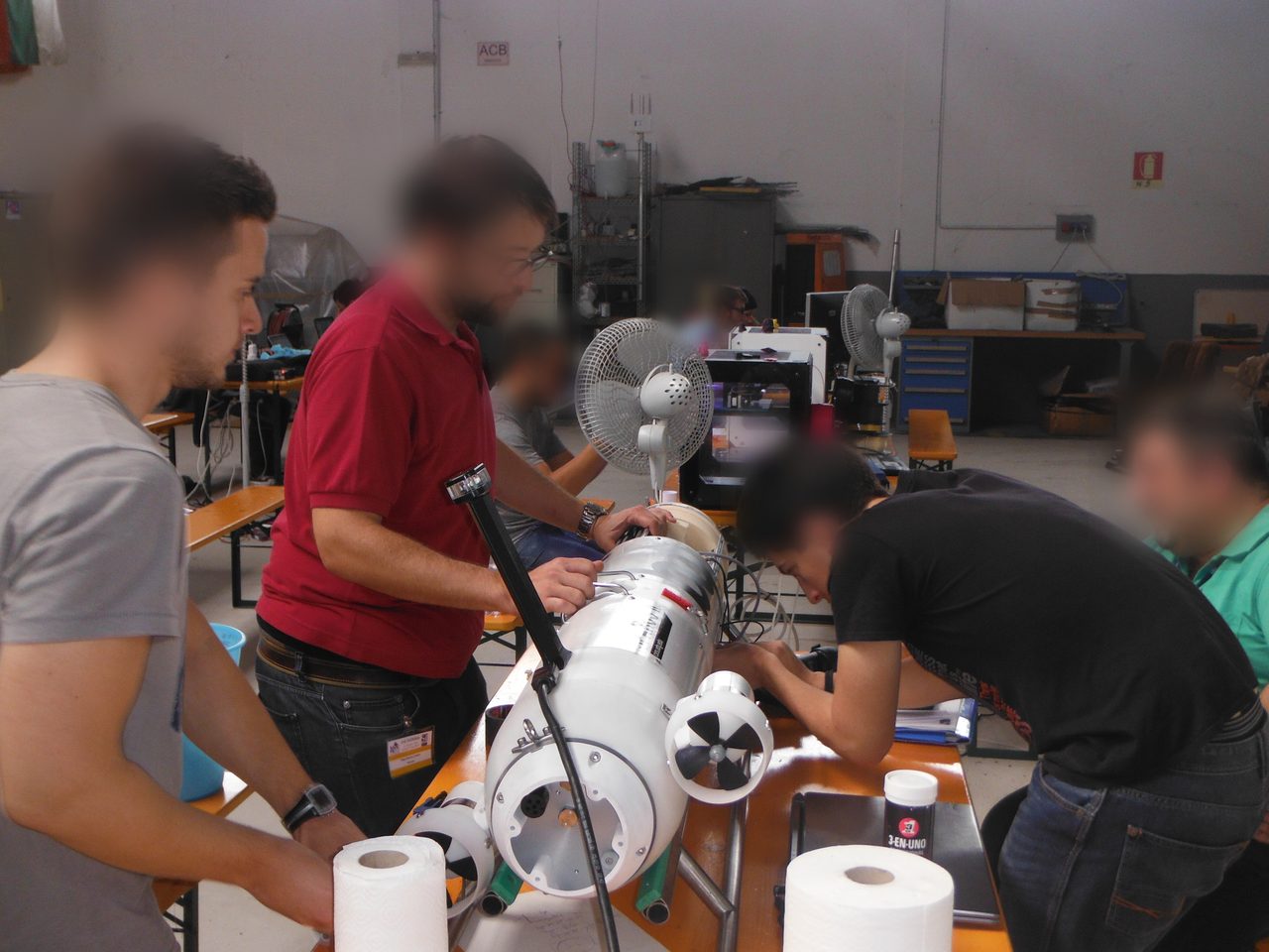 Team integration work on SPARUS II before field testing.